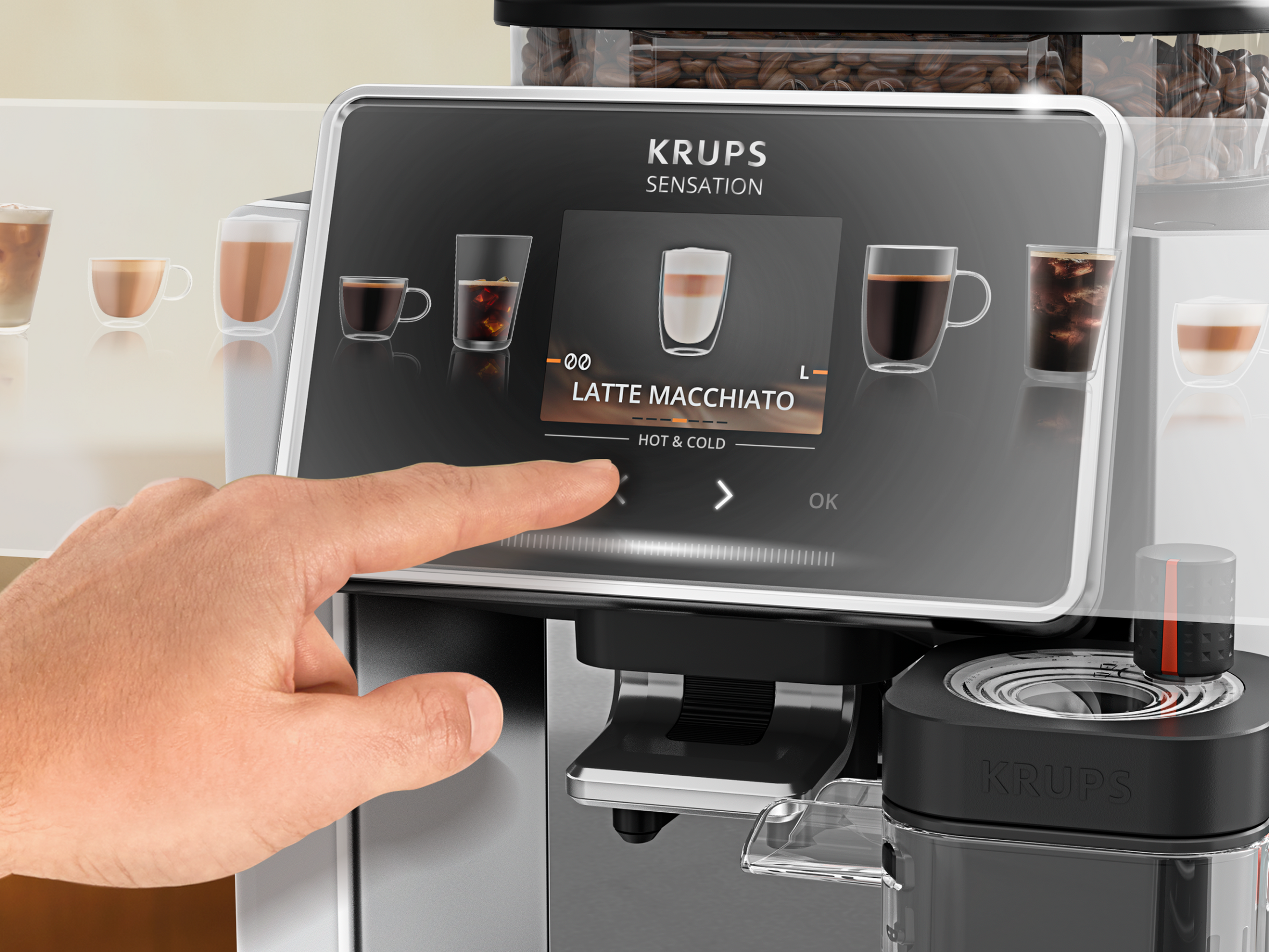 Una mano toca la pantalla de una cafetera KRUPS que muestra Latte Macchiato.