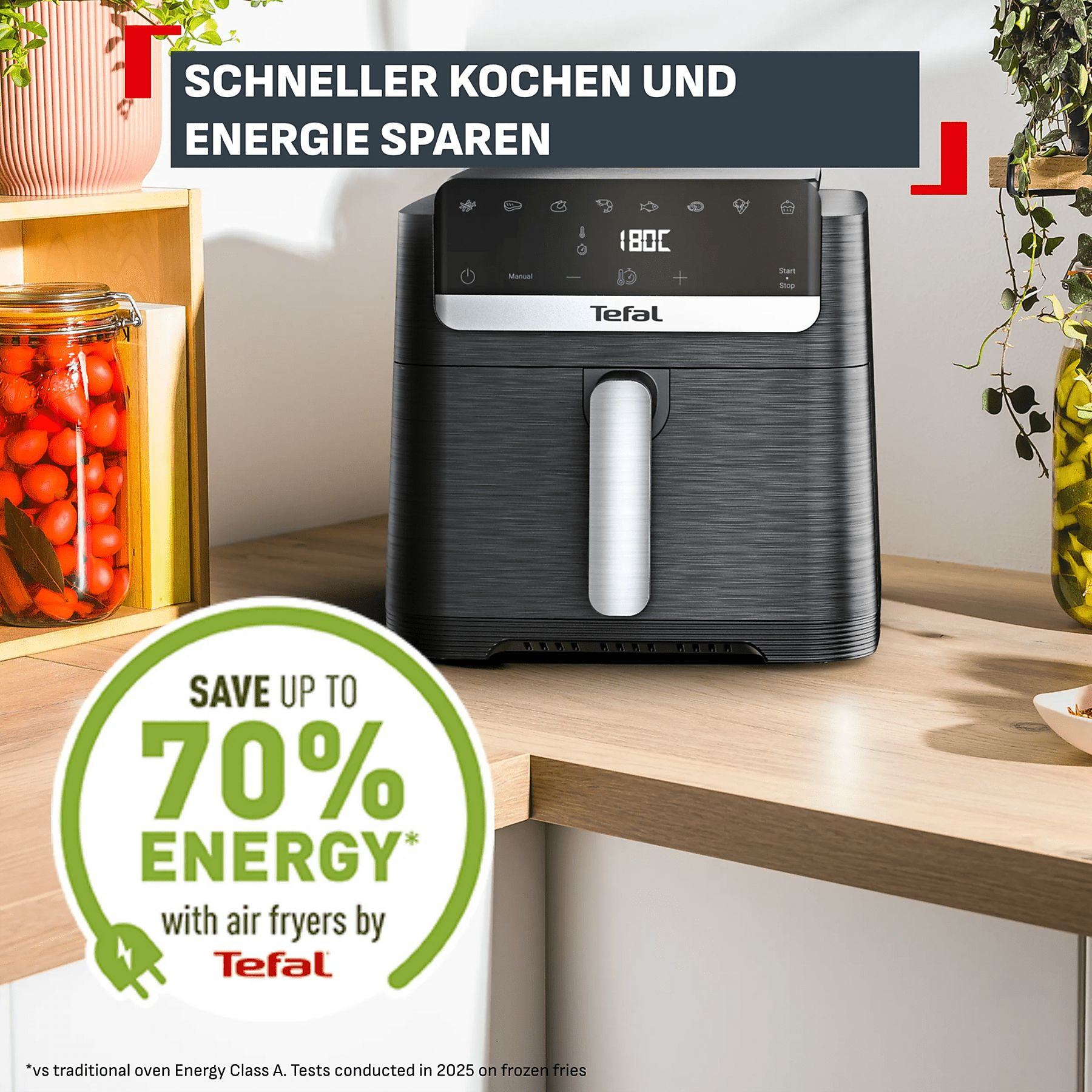 Une friteuse à air Tefal sur un comptoir avec des bocaux et des plantes.