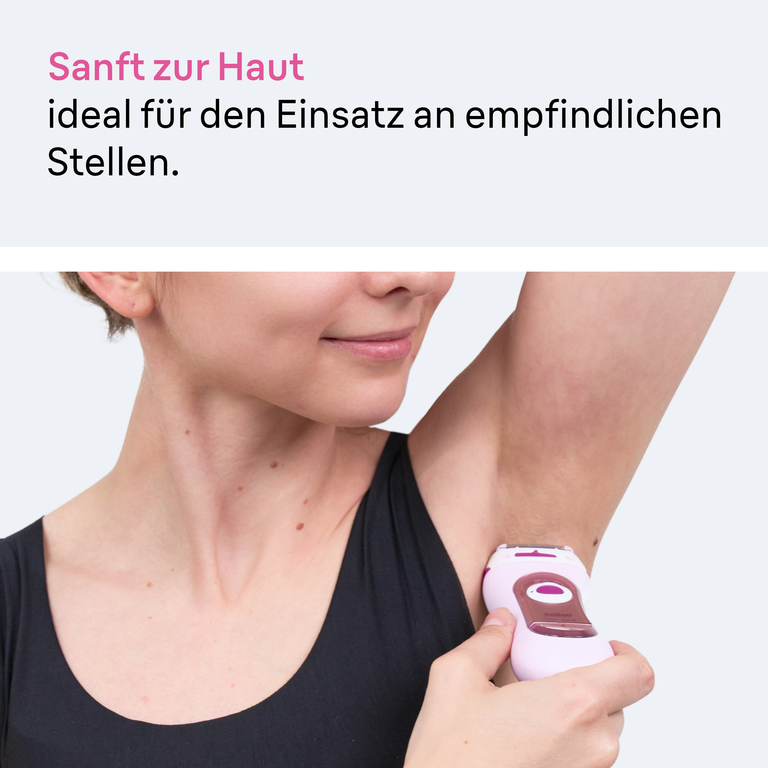 Une femme utilise un épilateur rose sous le bras. Doux pour la peau.