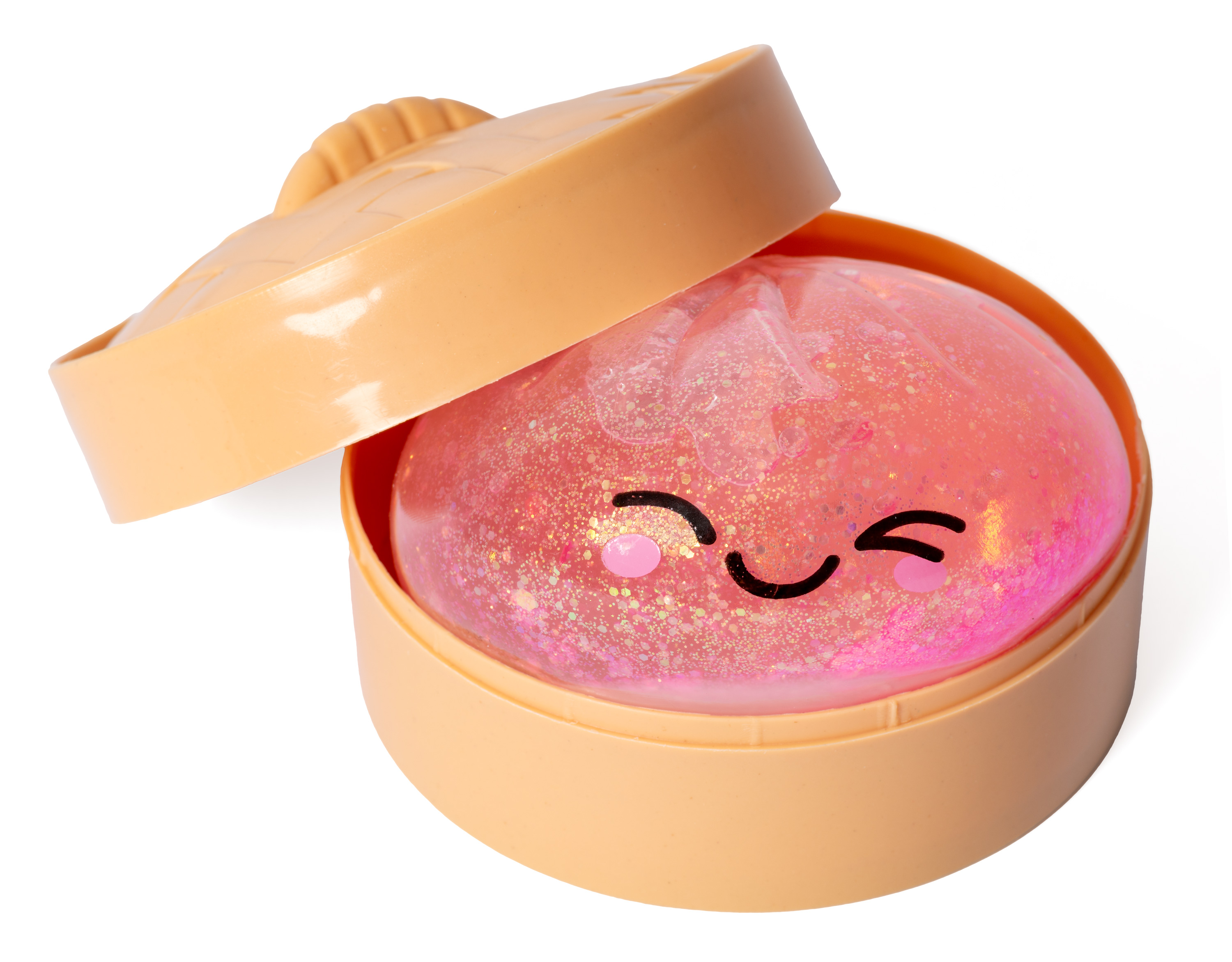 Ein glitzernder, pinker Ball mit Gesicht in einer beigen Schale.