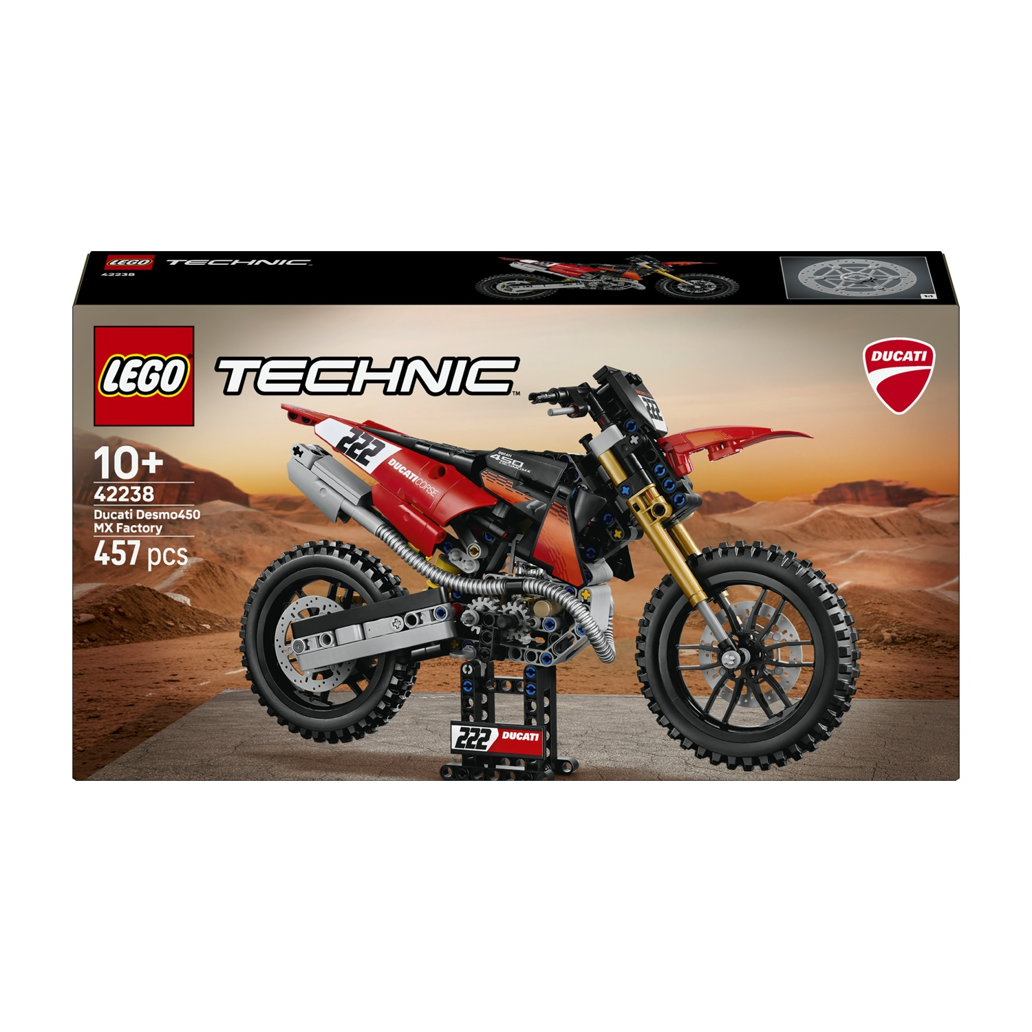 Moto modello LEGO Technic Ducati su espositore, sfondo desertico.