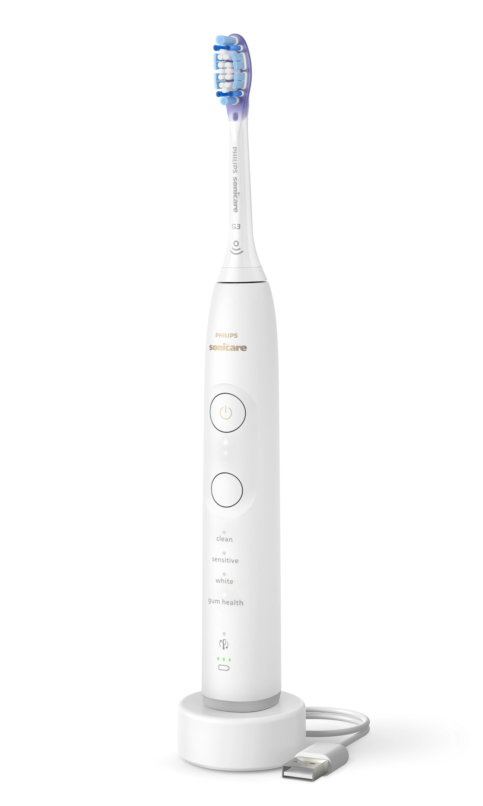 Biała szczoteczka elektryczna z niebiesko-białym włosiem na ładowarce z kablem USB.