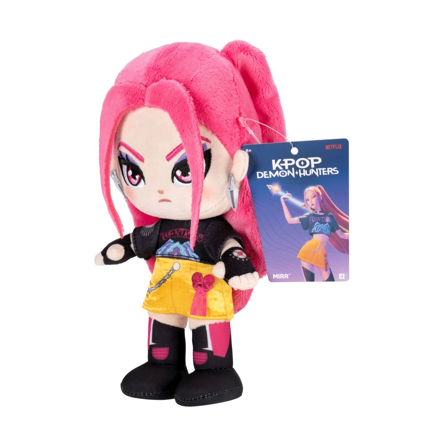 Un peluche con capelli rosa e gonna gialla, accanto a una carta K-Pop.