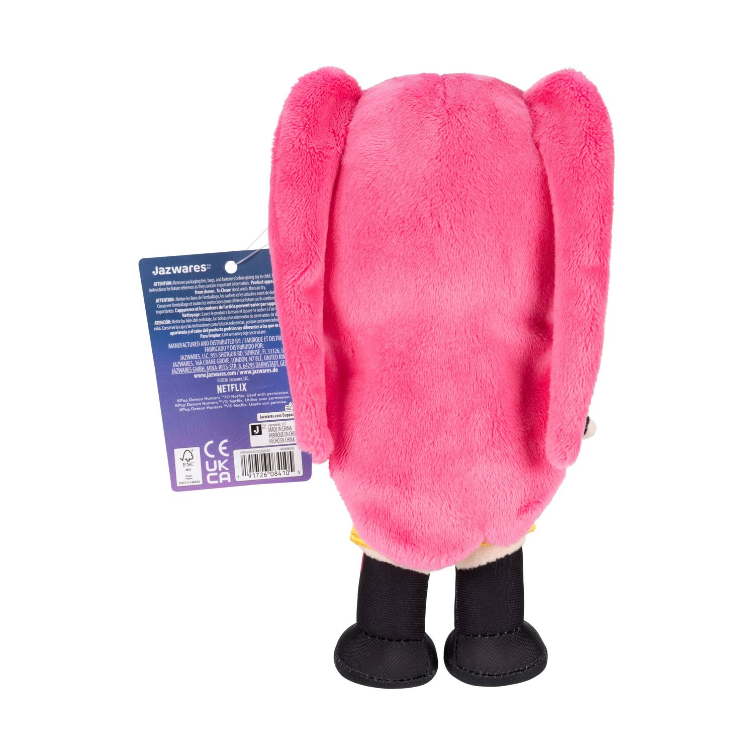 Un peluche rosa con lunghe orecchie e piedi neri si erge su sfondo bianco.