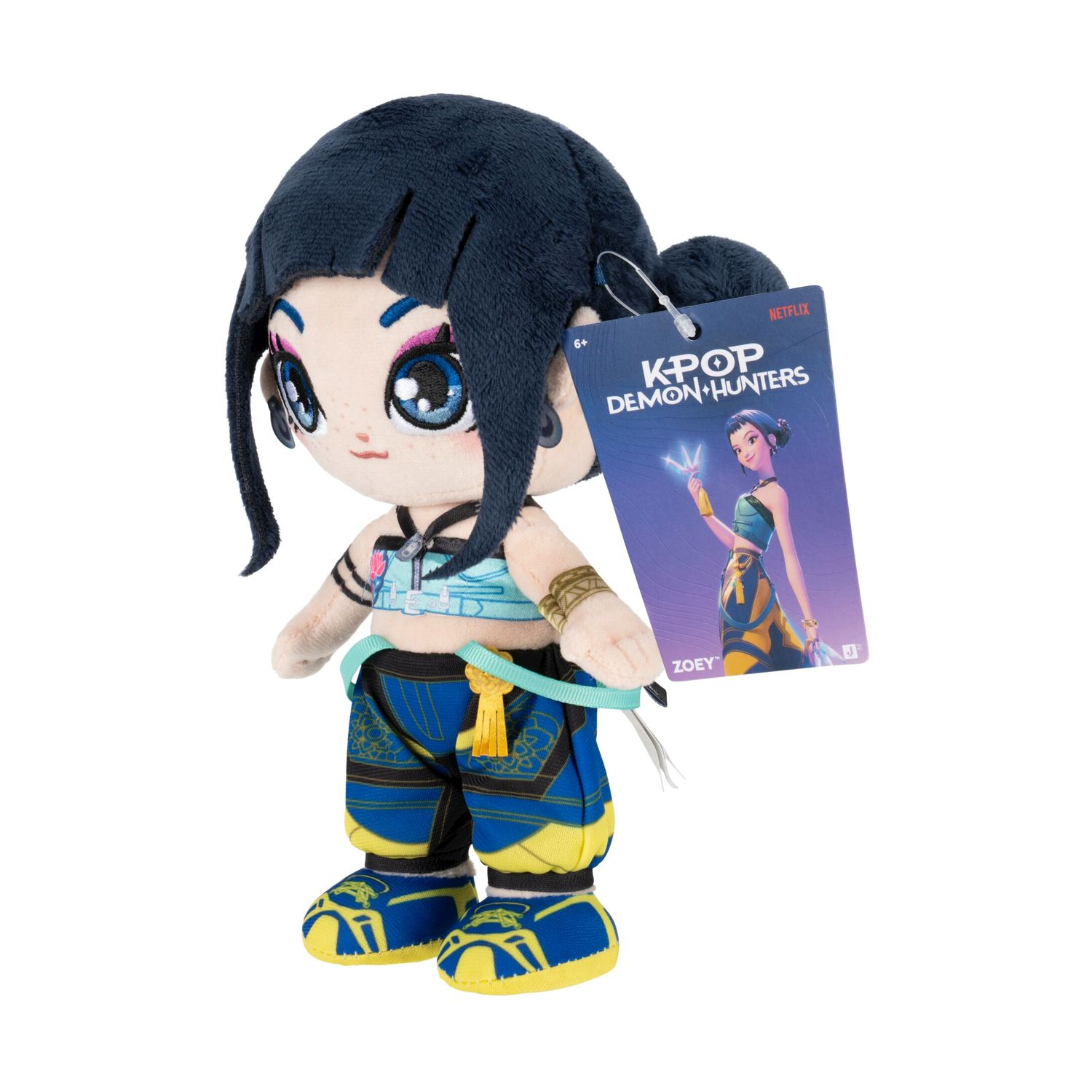 Peluche con capelli scuri, occhi blu e outfit colorato.