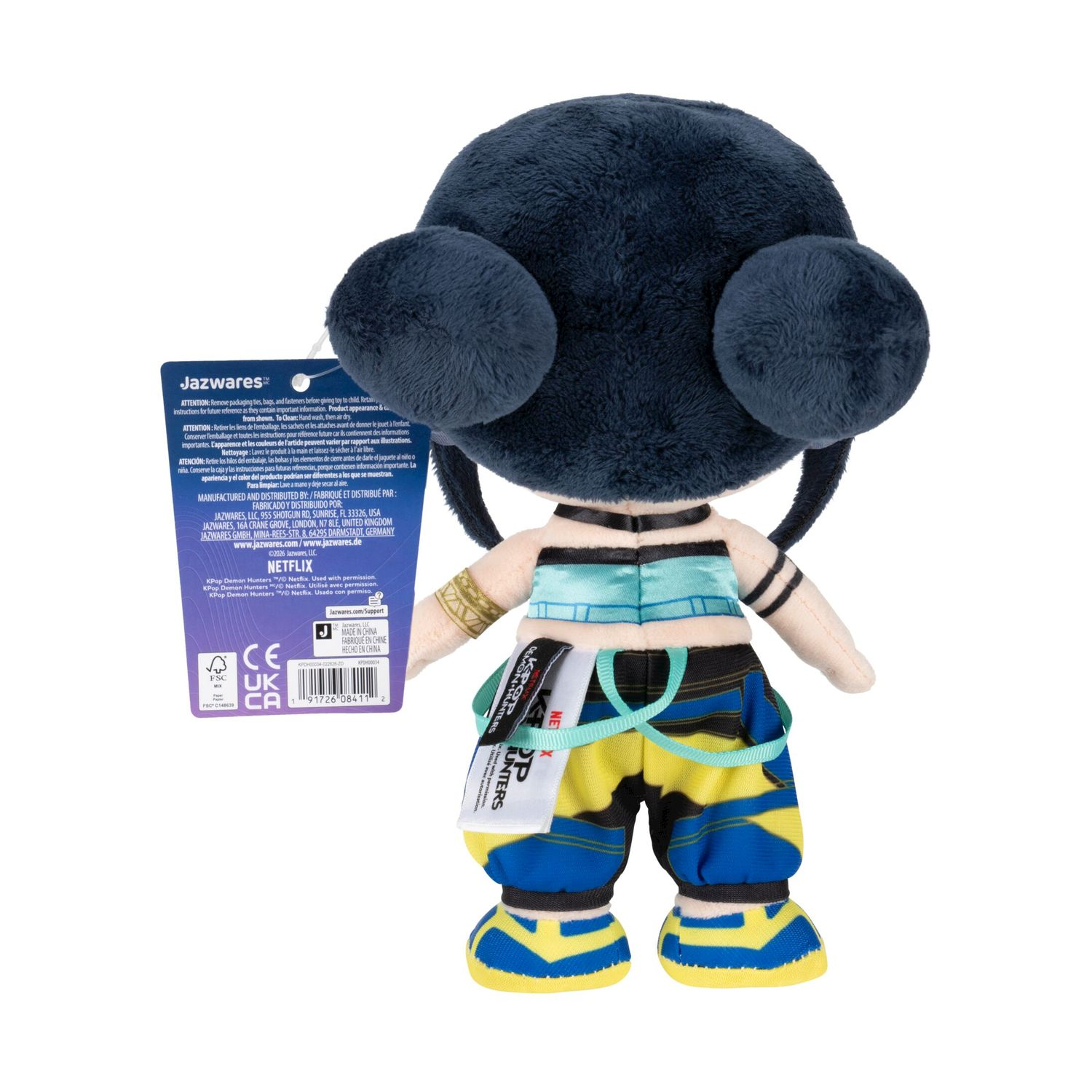 Peluche di un personaggio con capelli scuri, gilet blu e pantaloni a righe.