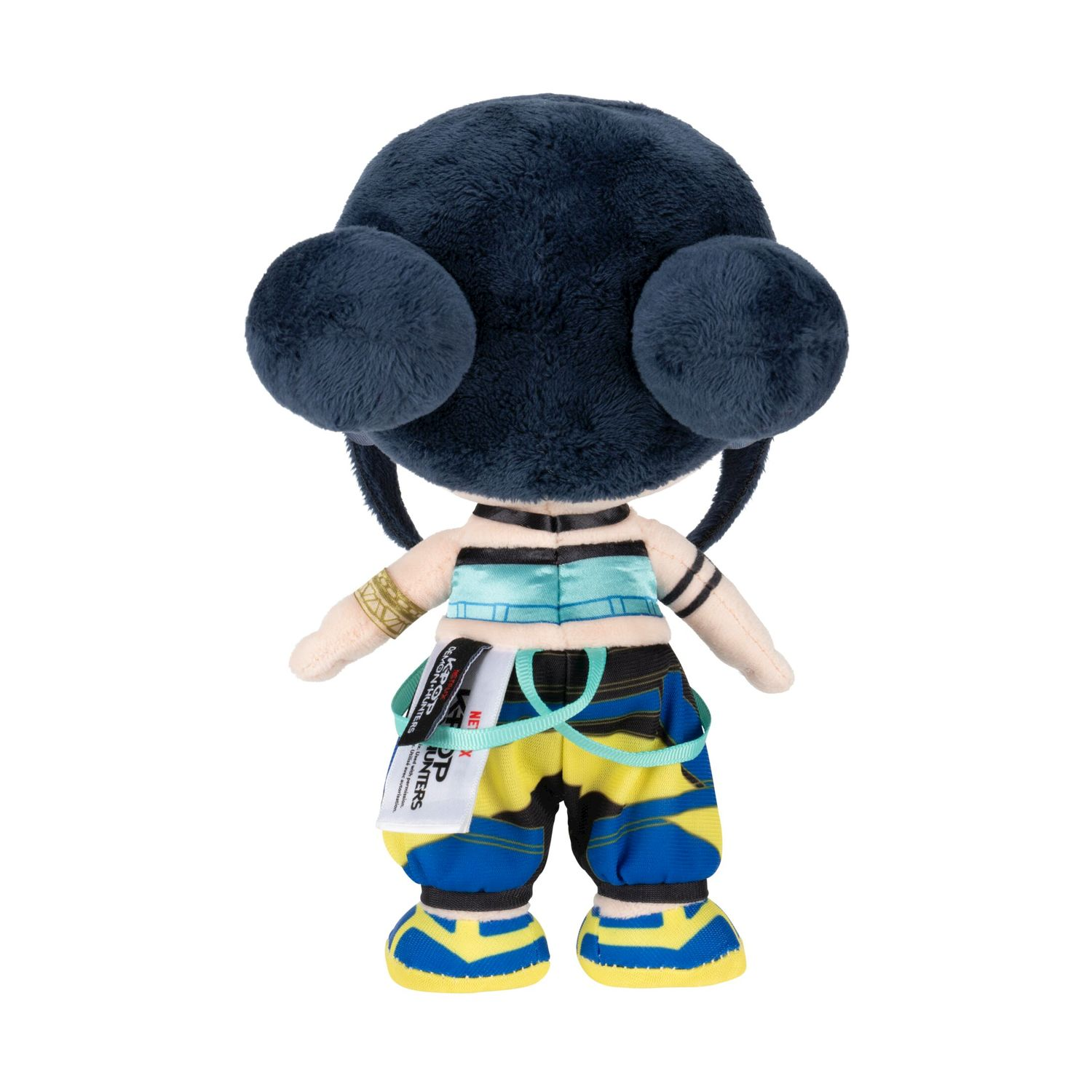 Peluche con capelli scuri, pantaloni blu e gialli e cuffie.
