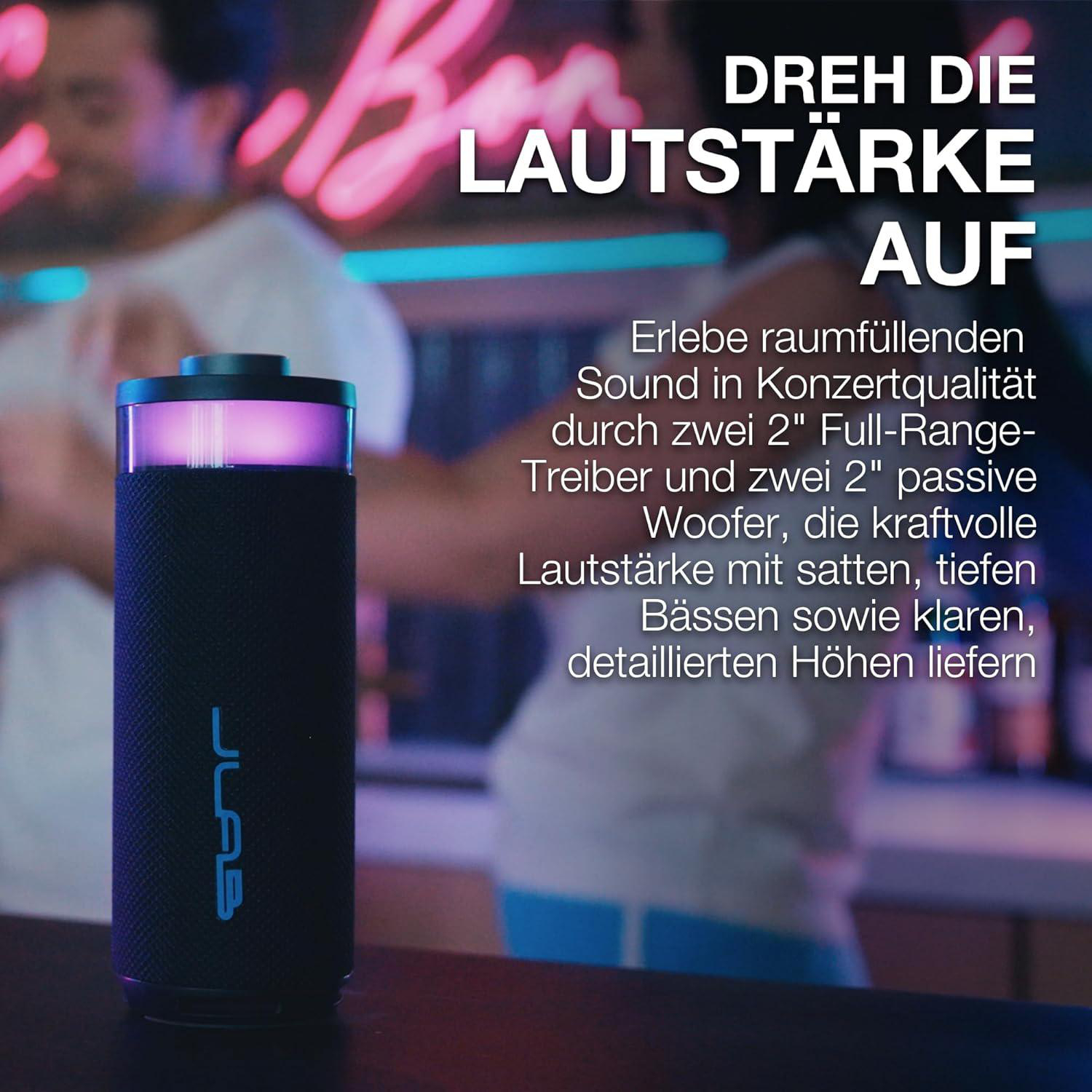 Schwarzer JLab Lautsprecher mit lila Licht, steht auf einer Theke.