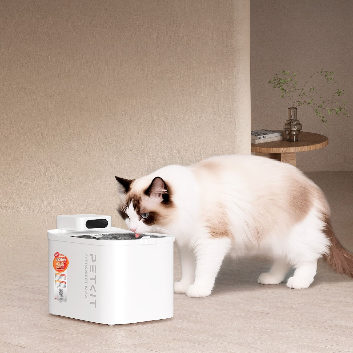 A cat drinks from a white pet water fountain.