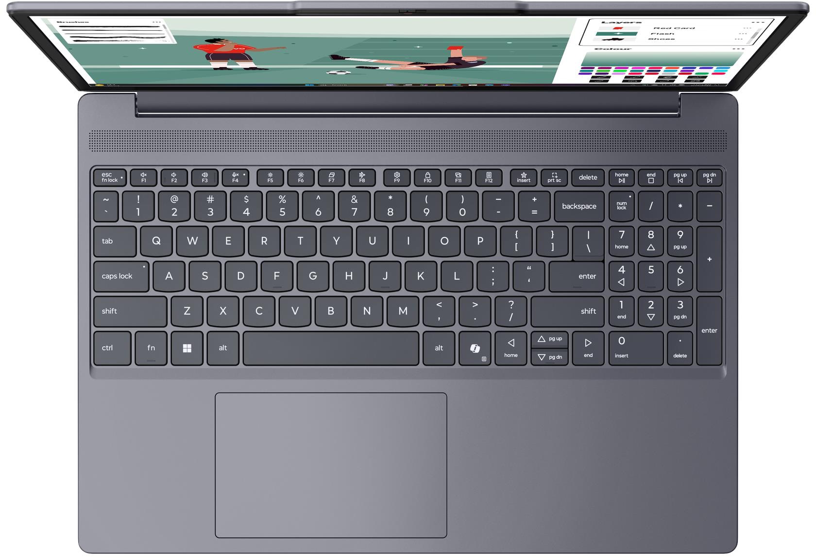 Egy laptop, amelyen focimeccs látható a képernyőn, a billentyűzet pedig jól látszik.