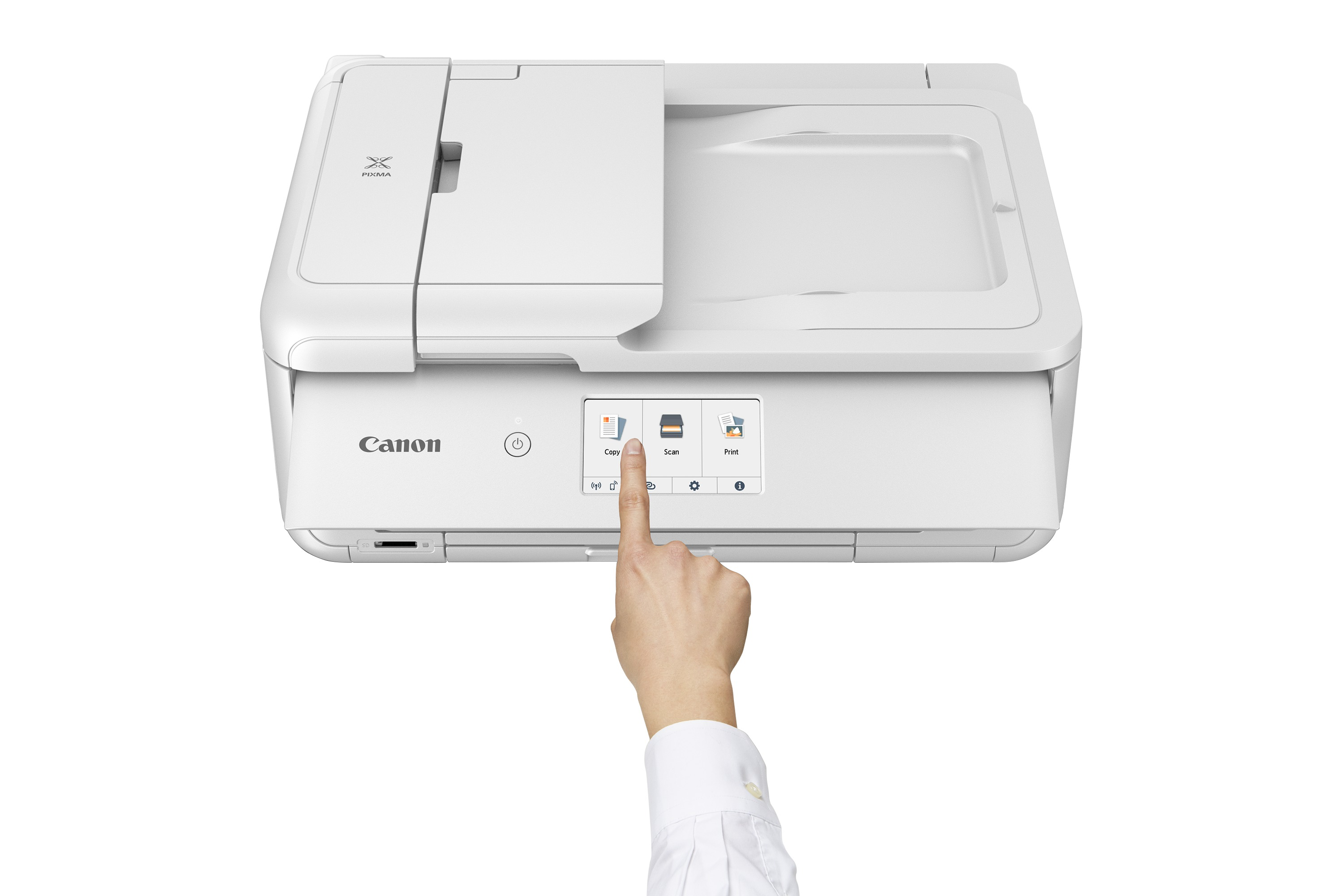 Une main touche l'écran d'une imprimante Canon Pixma blanche.