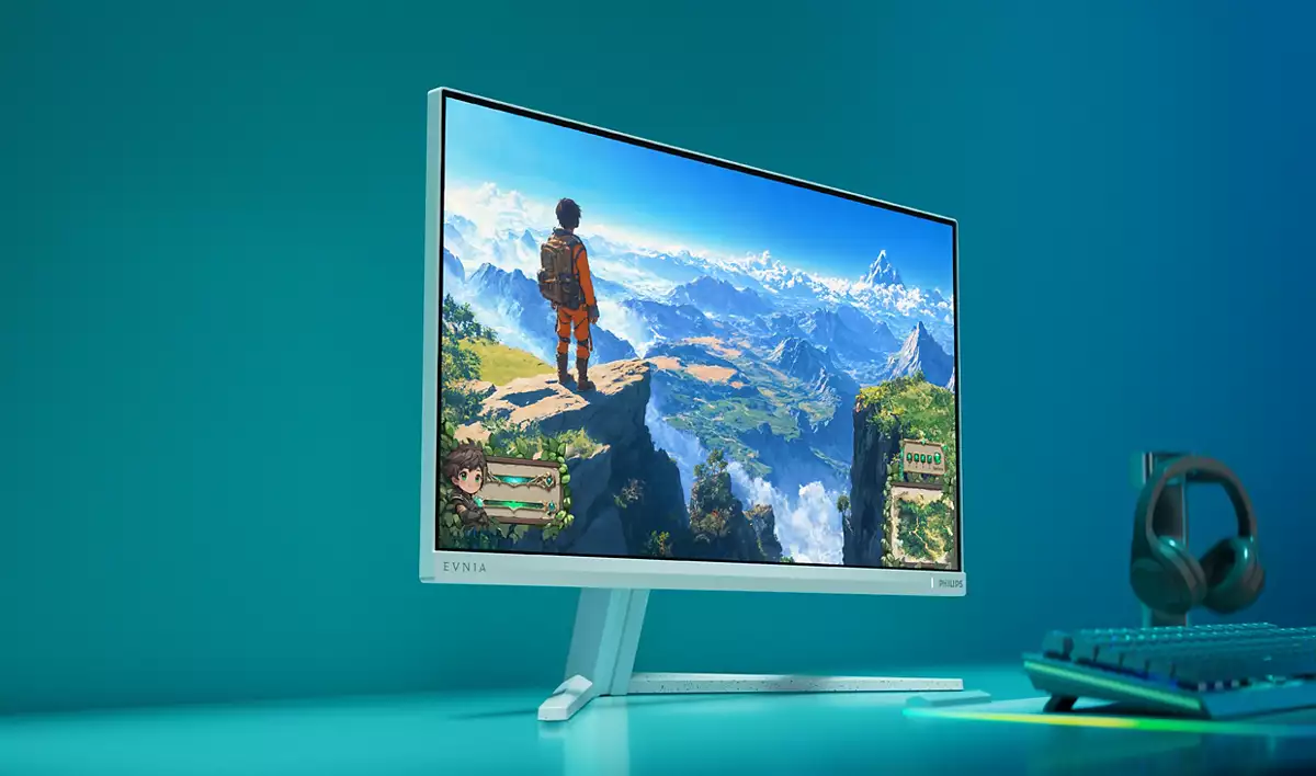 Ein Monitor zeigt eine fantastische Landschaft mit einem Wanderer, daneben Kopfhörer und Tastatur.