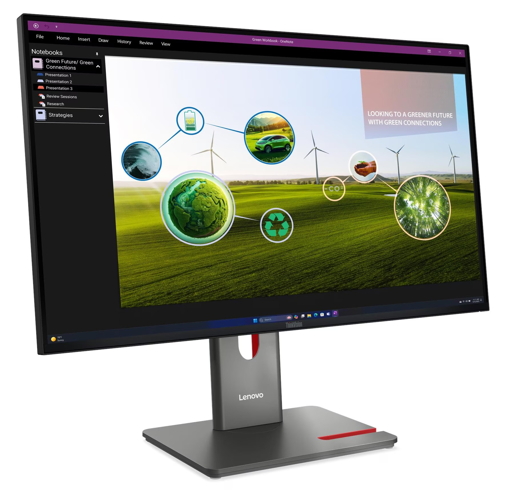 Monitor Lenovo wyświetla stronę OneNote z grafiką zielonej przyszłości, turbinami wiatrowymi i tekstem.