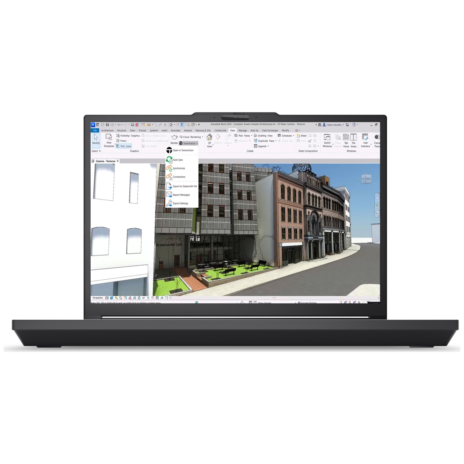 A laptop displays 3D architectural rendering software with buildings and street scene.