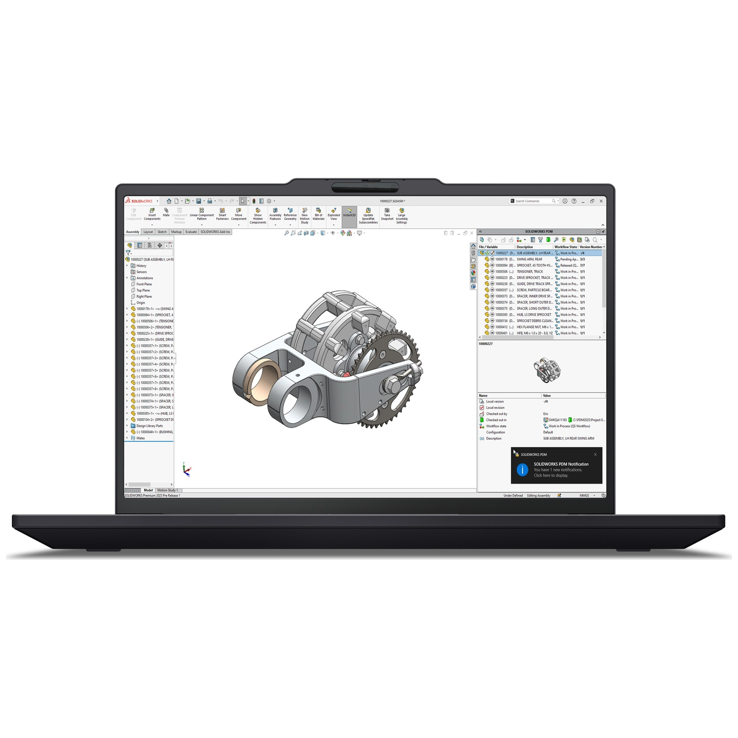 A laptop displays 3D design software with a mechanical part in focus.