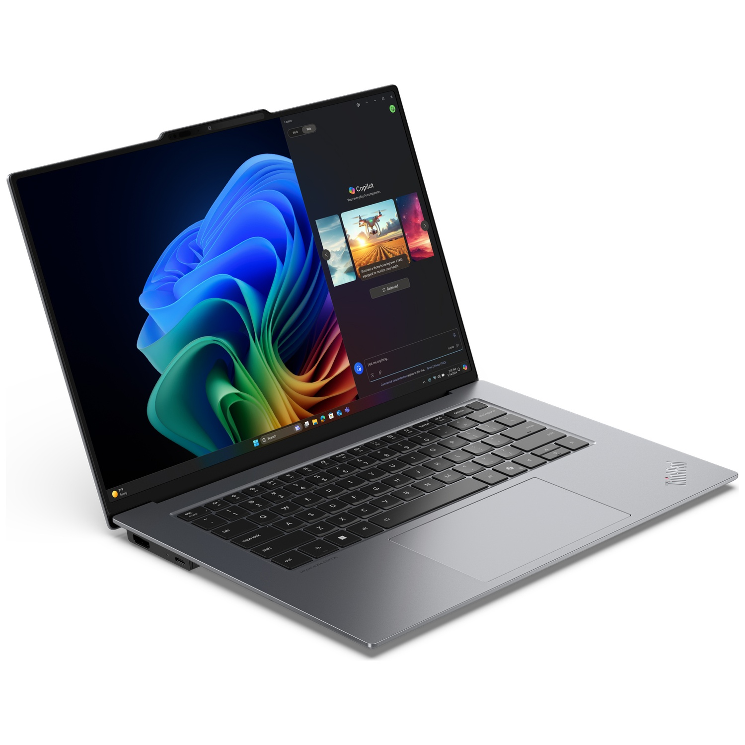 A silver laptop displays a colorful abstract wallpaper and the Copilot AI interface.