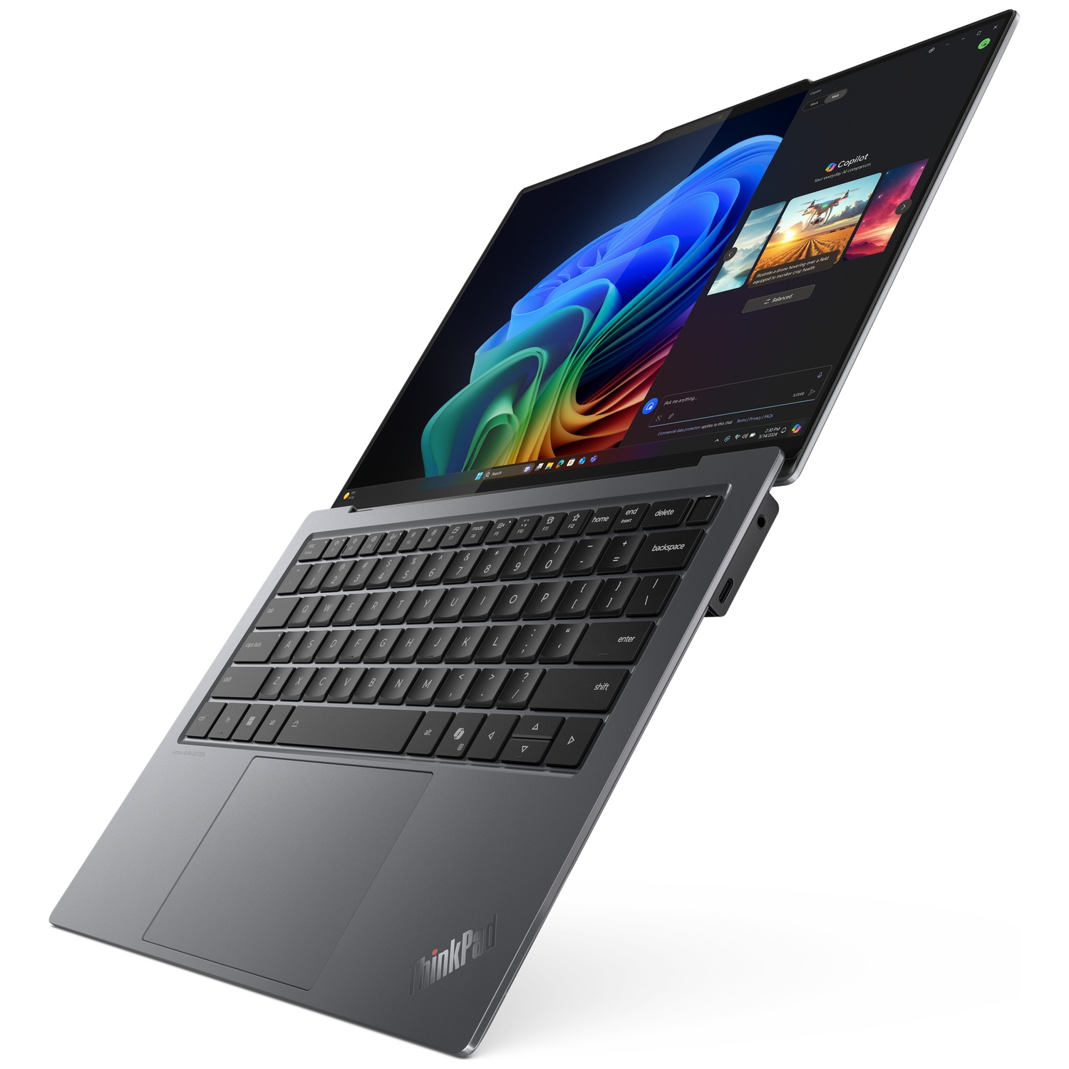 A gray ThinkPad laptop with its screen open, displaying a colorful wallpaper.