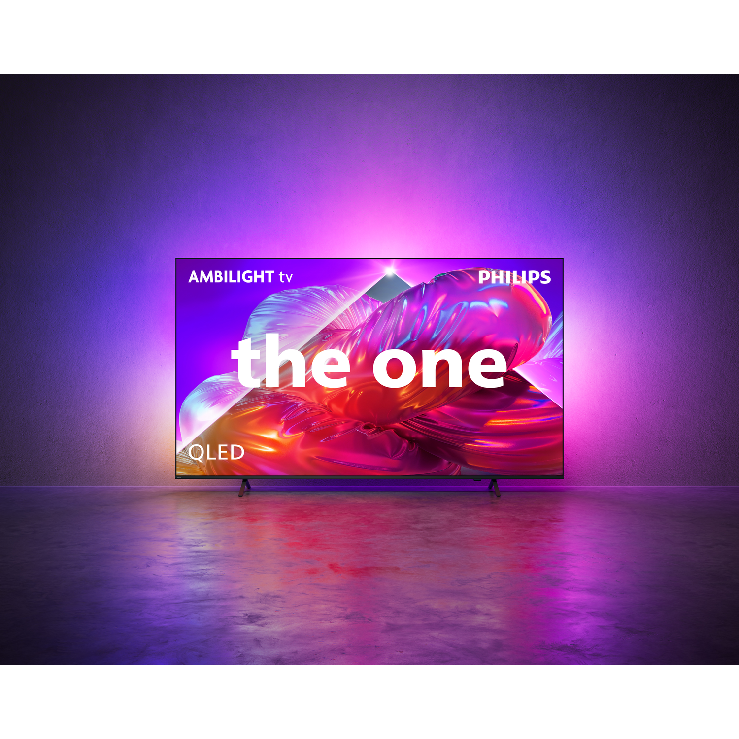 A Philips Ambilight QLED TV displaying the text 'the one' on its screen.