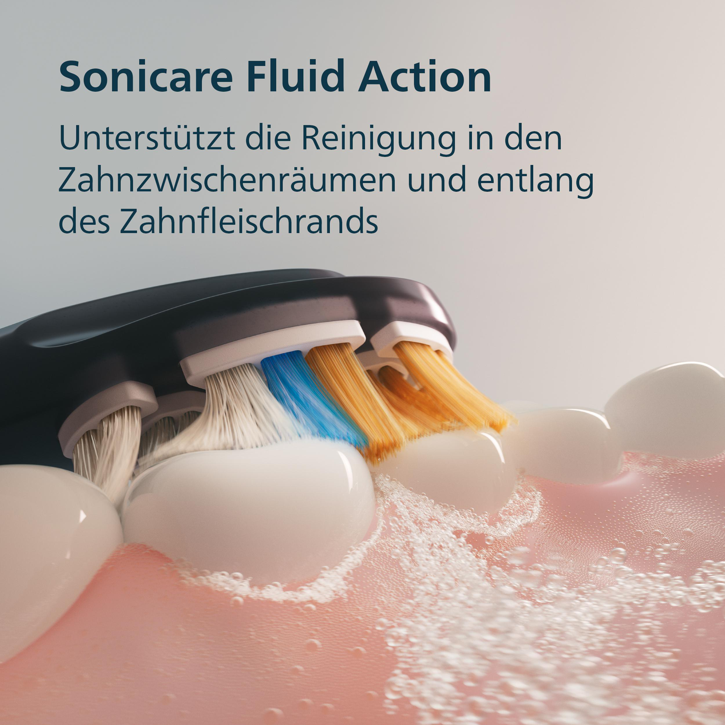 Elektrische Zahnbürste reinigt Zähne mit schäumender Flüssigkeit.