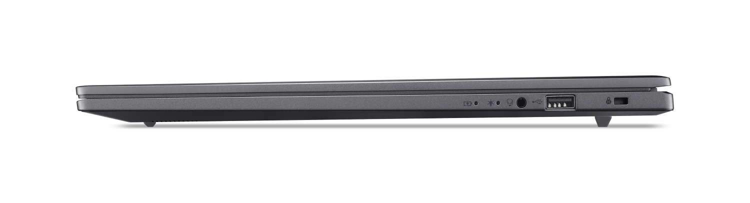 Szary laptop widok z boku pokazujący porty: USB, słuchawki, głośnik.
