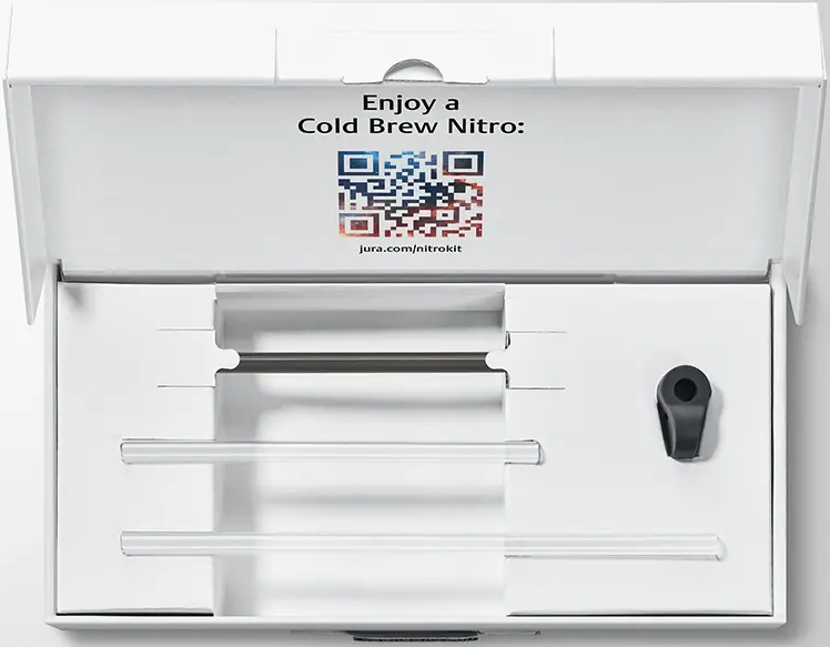Una scatola bianca con accessori Cold Brew Nitro: parti in vetro e una clip nera.