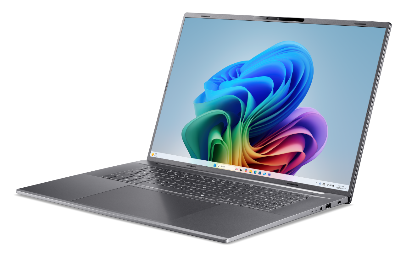 Szary laptop z kolorową tapetą na ekranie.