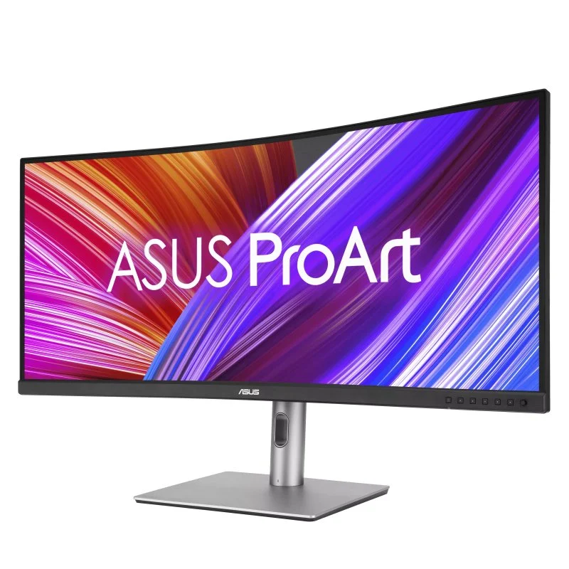 Un monitor curvo ASUS ProArt muestra un fondo colorido con un soporte plateado.