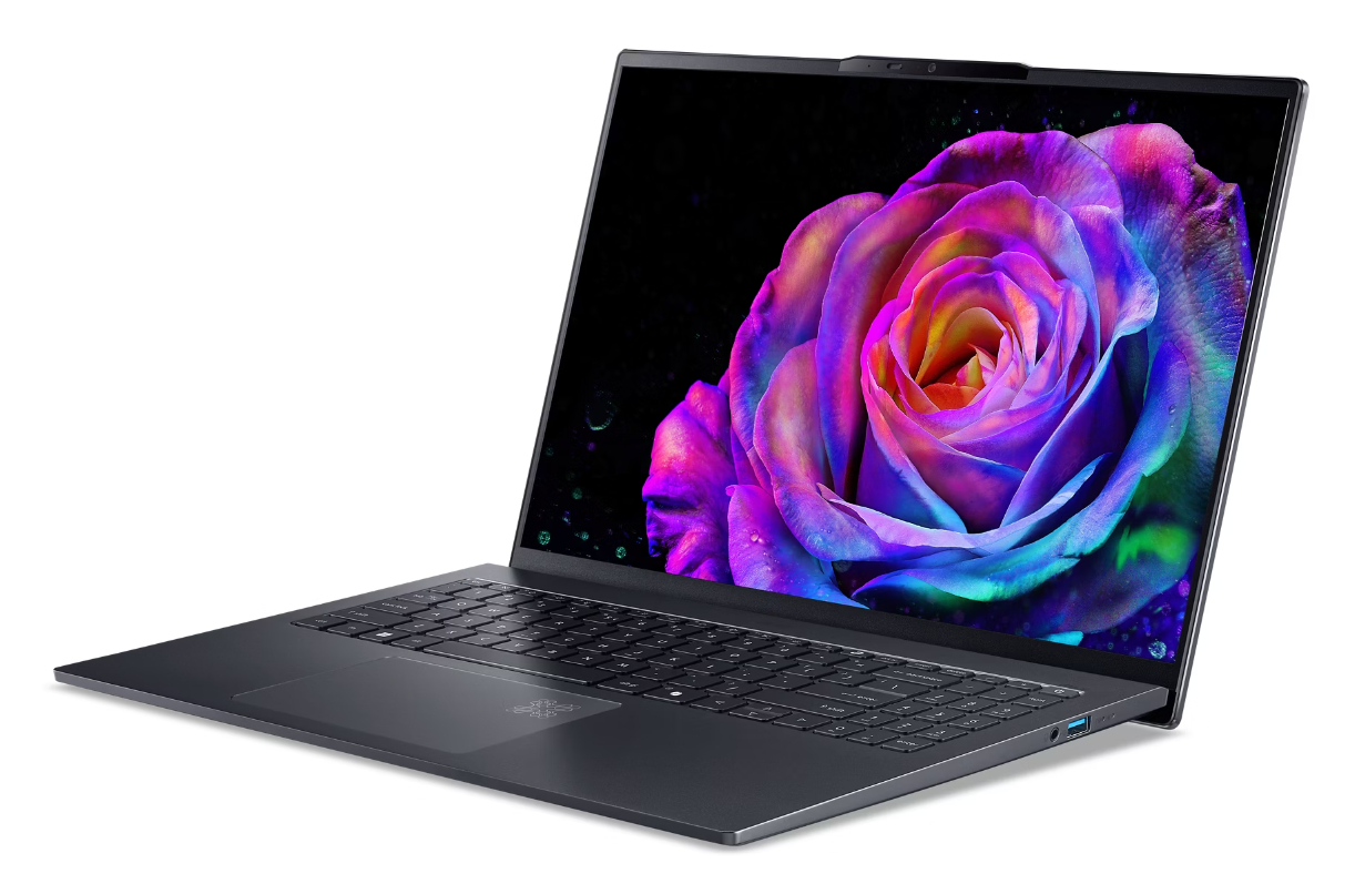 Ciemny laptop z żywą tapetą z różą. Klawiatura jest widoczna.
