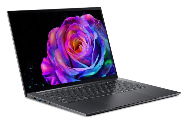 Otwarty laptop wyświetla kolorową różę na ekranie.
