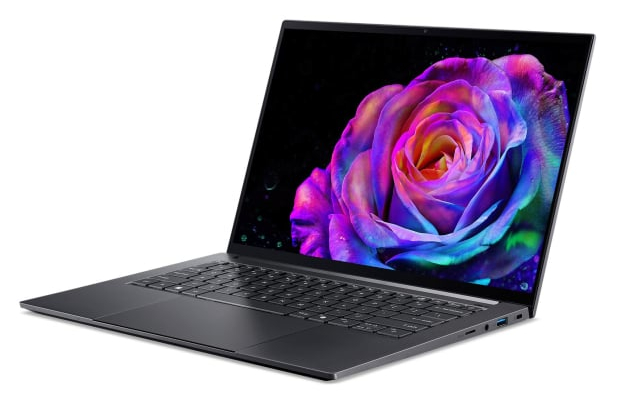 Otwarty laptop wyświetlający kolorową różę na ekranie.