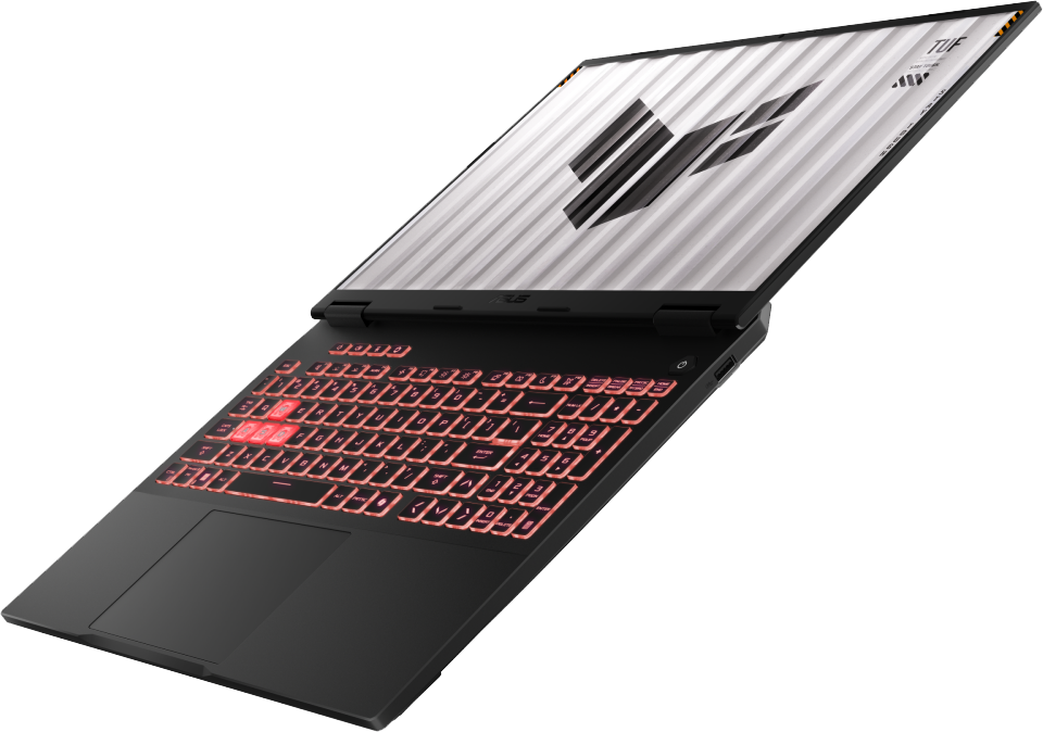 Fekete laptop világító billentyűzettel és TUF logóval a képernyőn.