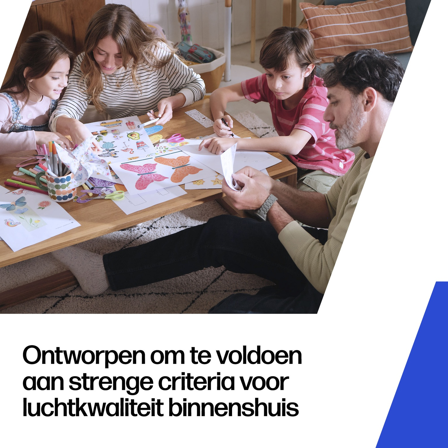 Family crafts butterflies at a table indoors with pens and paper.