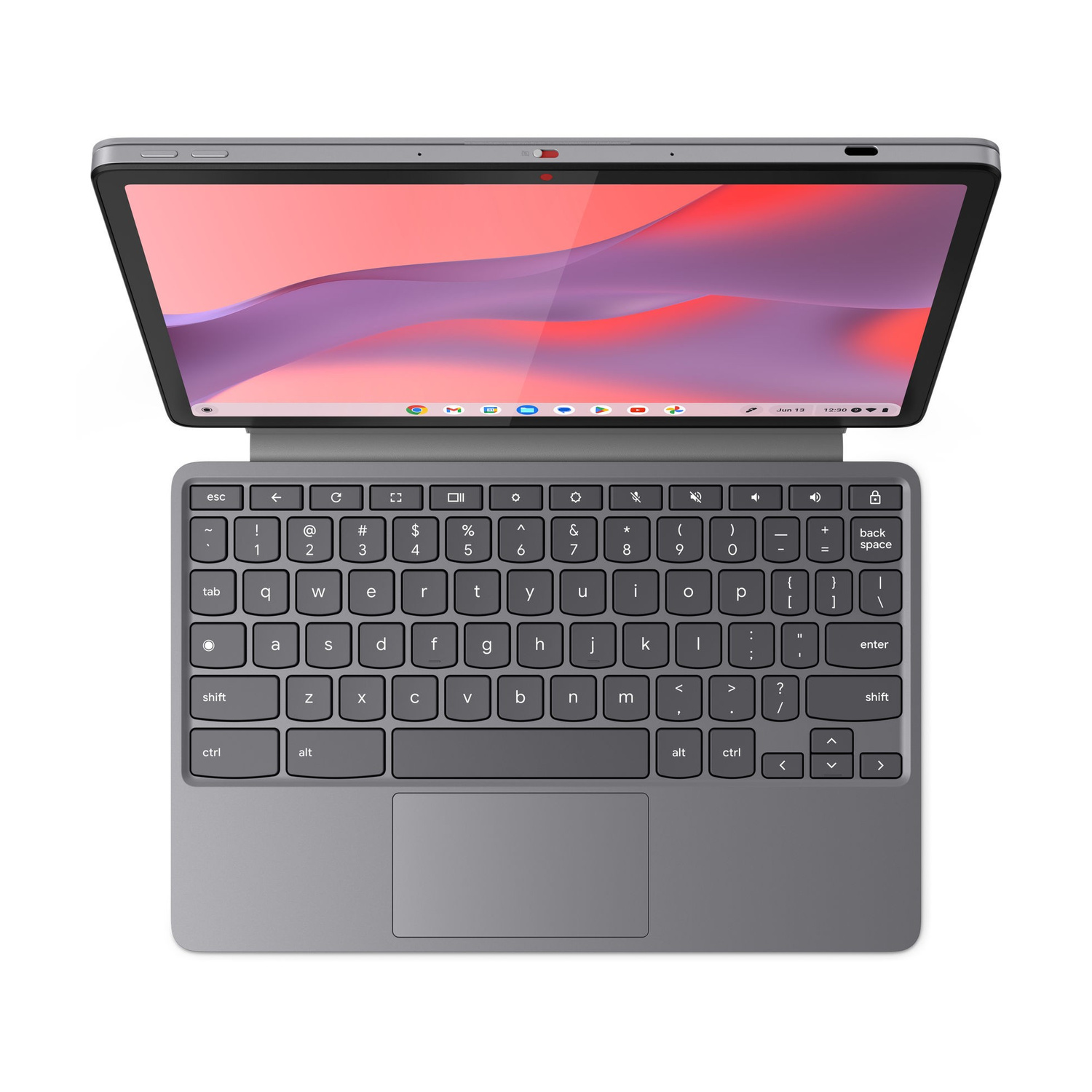 Un laptop grigio con lo schermo aperto, che mostra uno sfondo rosa e viola.