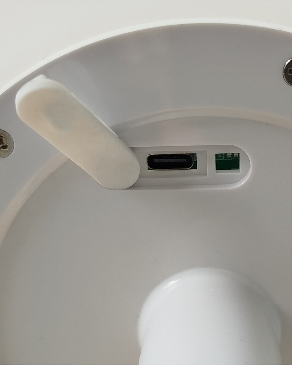 Egy fehér USB-C port és egy zöld chip egy fehér eszközön.