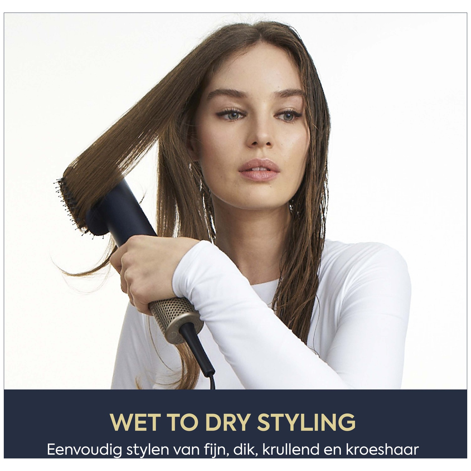 Woman with wet hair styling it with a blow dryer and round brush.