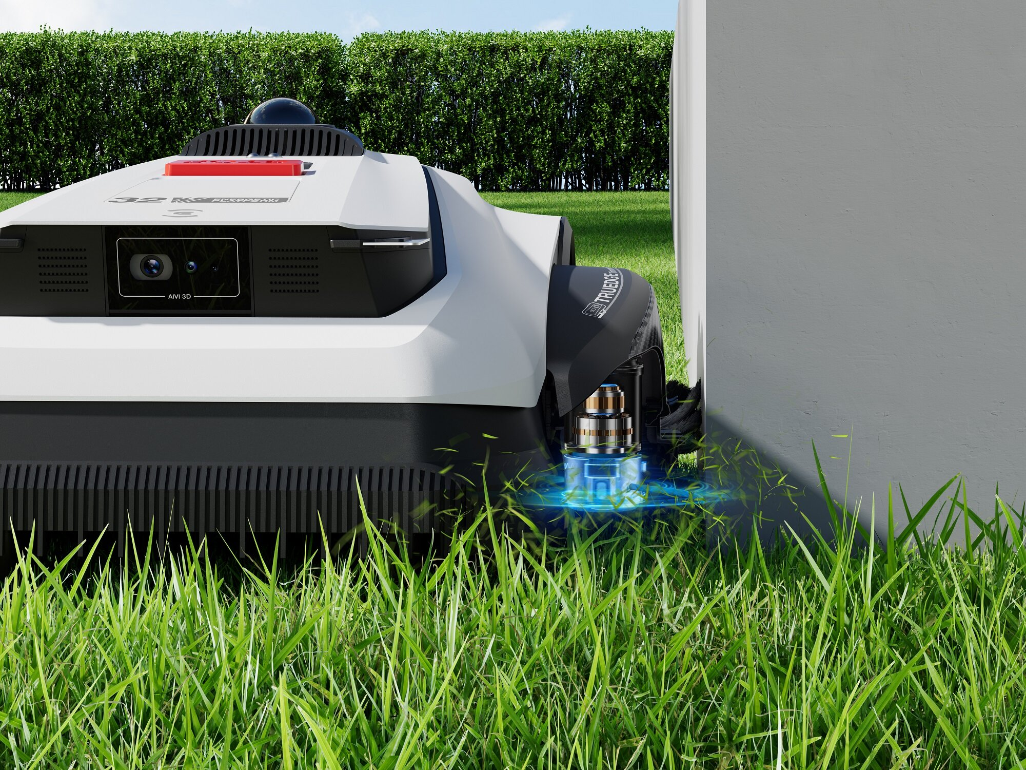 Robot koszący trawę przycina zieloną trawę obok szarego muru i żywopłotu.