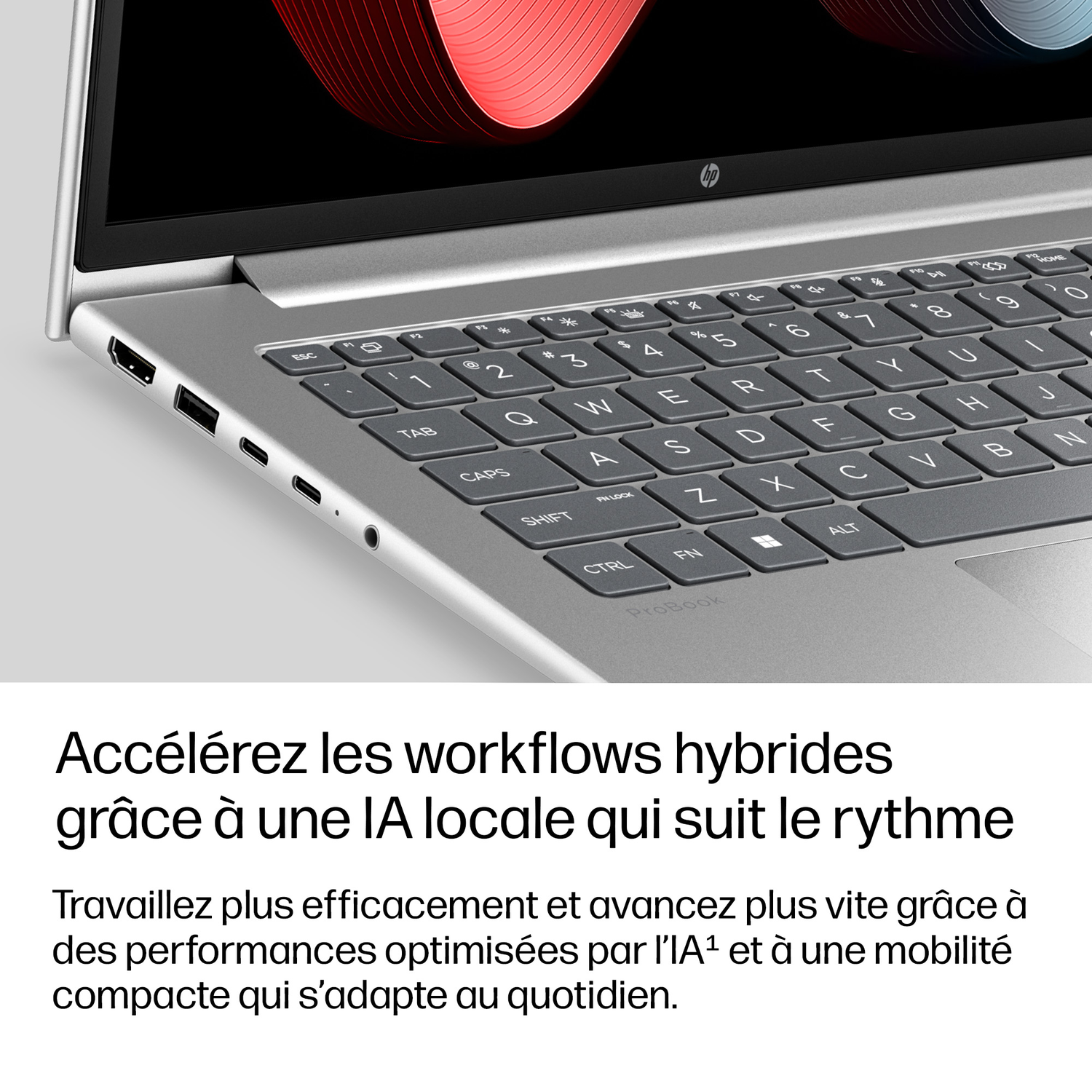 Ordinateur portable argenté avec clavier et port HDMI. Motif rouge à l'écran.
