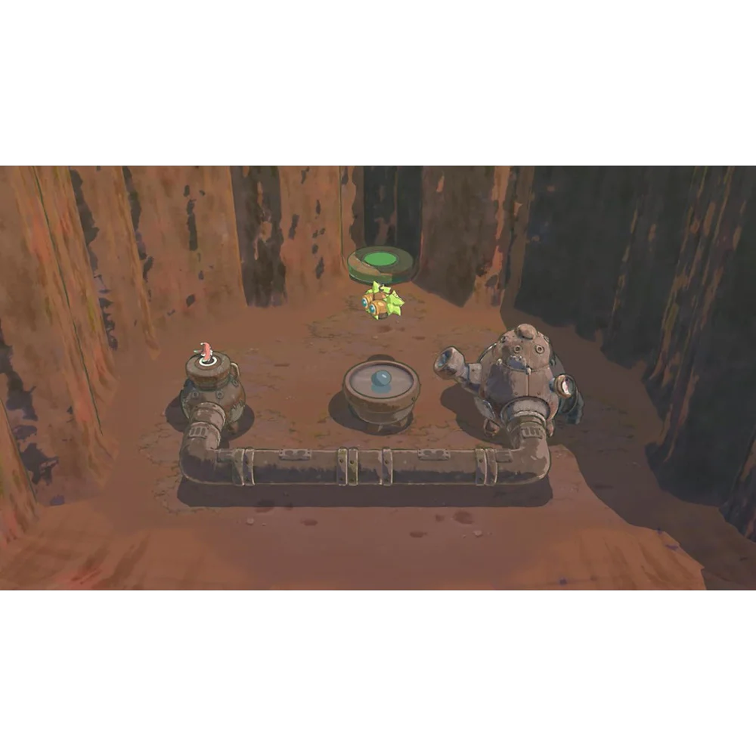 Een kleine robot staat voor pijpen en een tank in een grot.