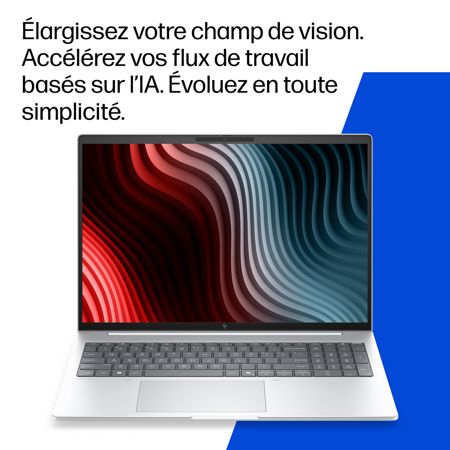 Un ordinateur portable argenté affiche un fond d'écran abstrait, avec un clavier.