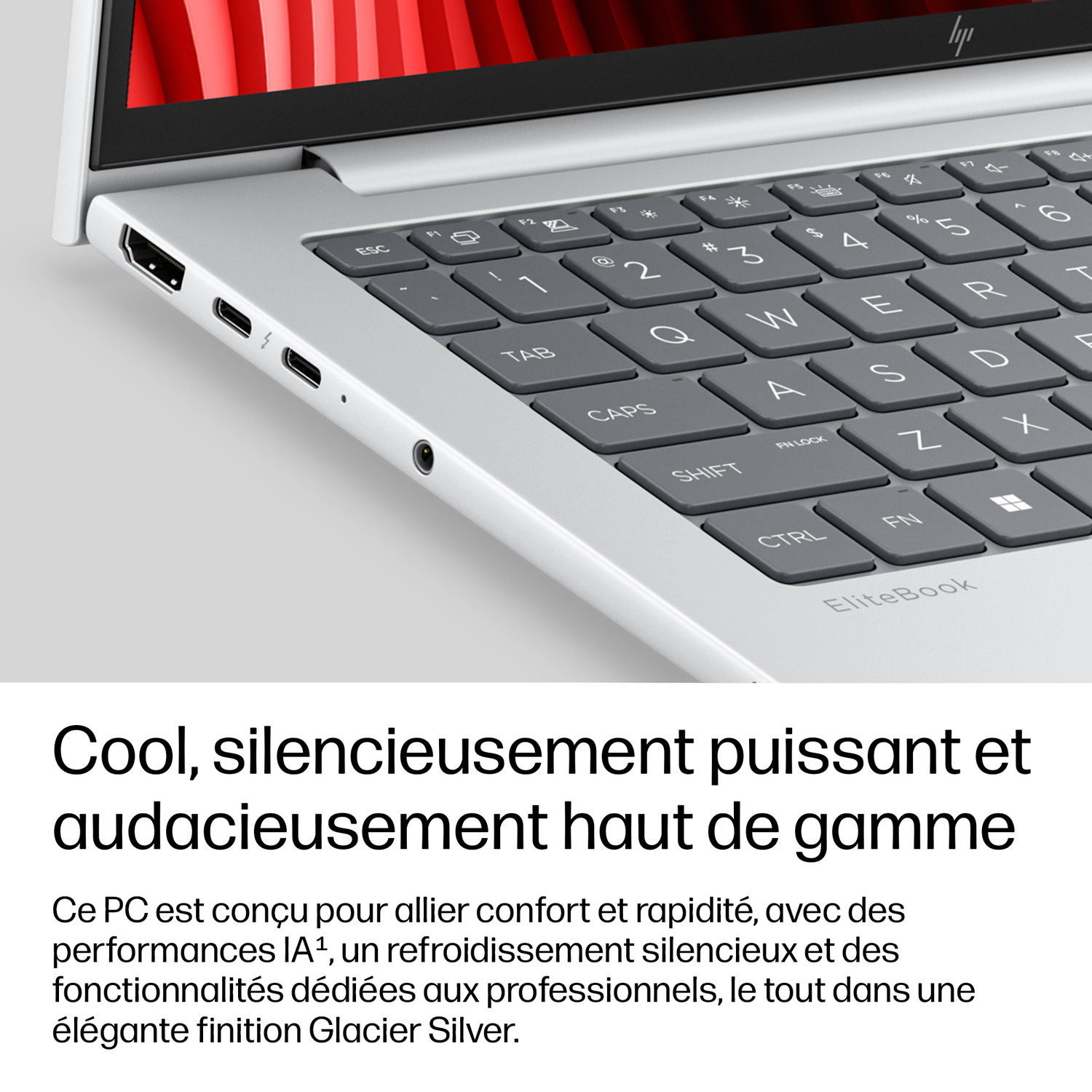 Gros plan sur un clavier et des ports d'un ordinateur portable argenté.