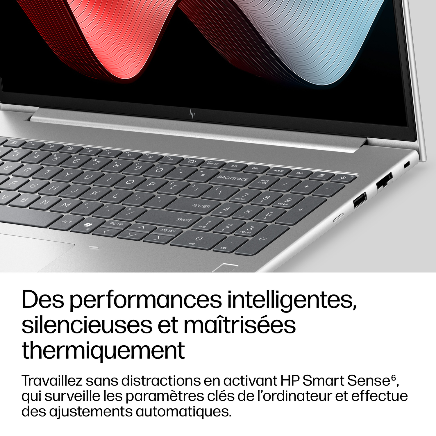 Un ordinateur portable argenté avec clavier et écran affichant un graphique.