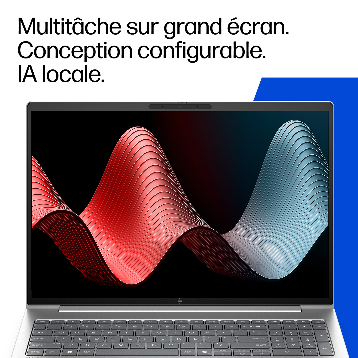 Ordinateur portable argenté affichant des motifs ondulés abstraits rouges et bleus.