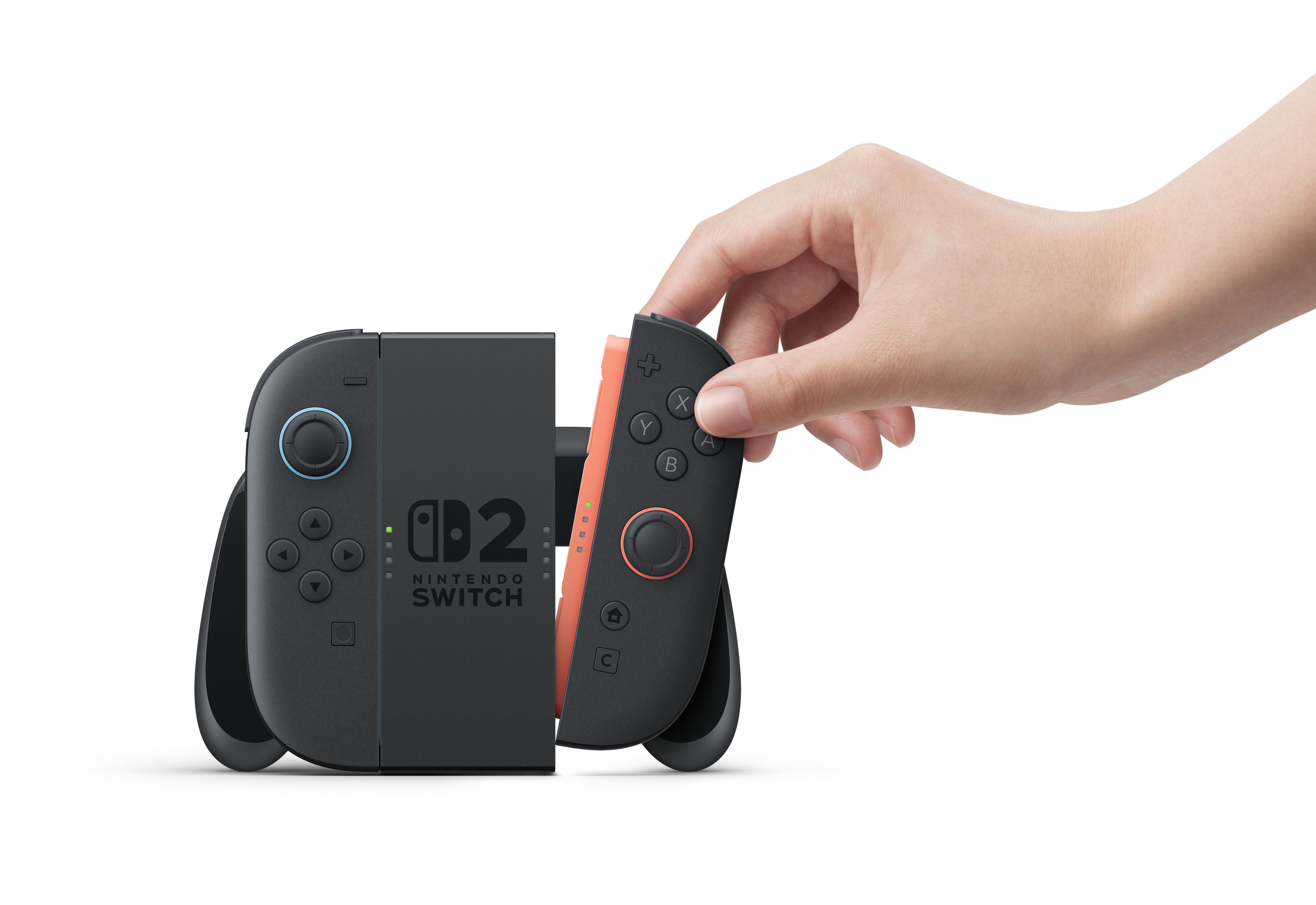 Bir el, gri bir Nintendo Switch konsoluna turuncu Joy-Con takıyor.
