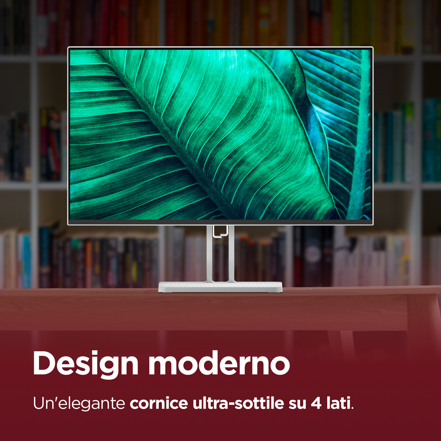Monitor moderno con primo piano di foglie verdi; librerie sullo sfondo.