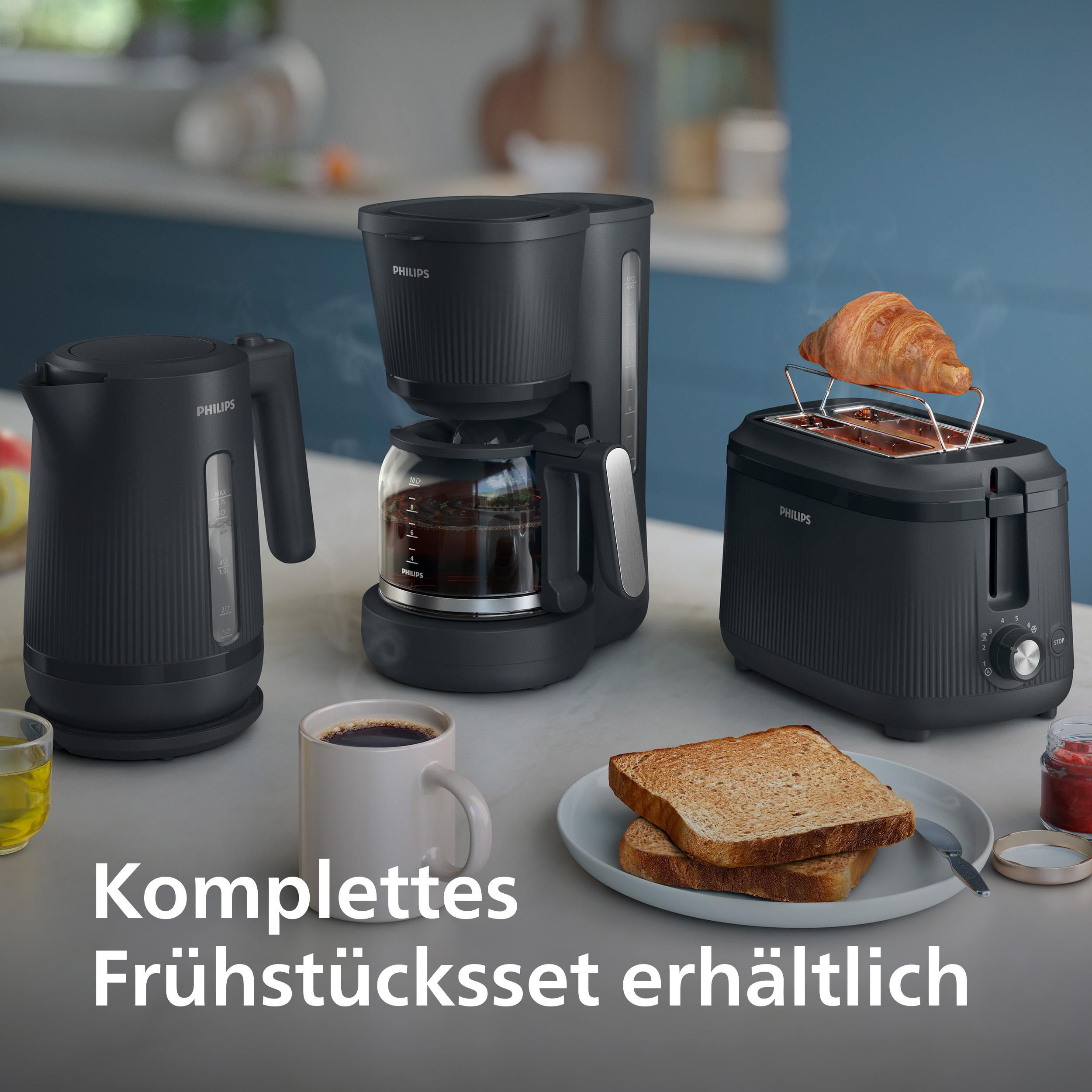 Schwarzes Frühstücksset: Wasserkocher, Kaffeemaschine, Toaster mit Croissant, Brot.