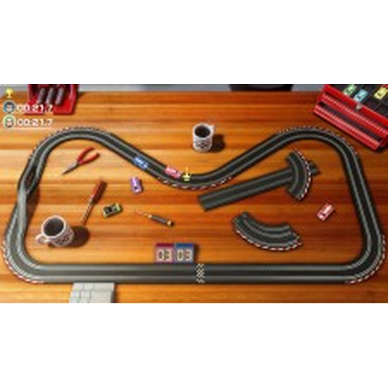 A toy race car track on a wooden table with tools and mugs.
