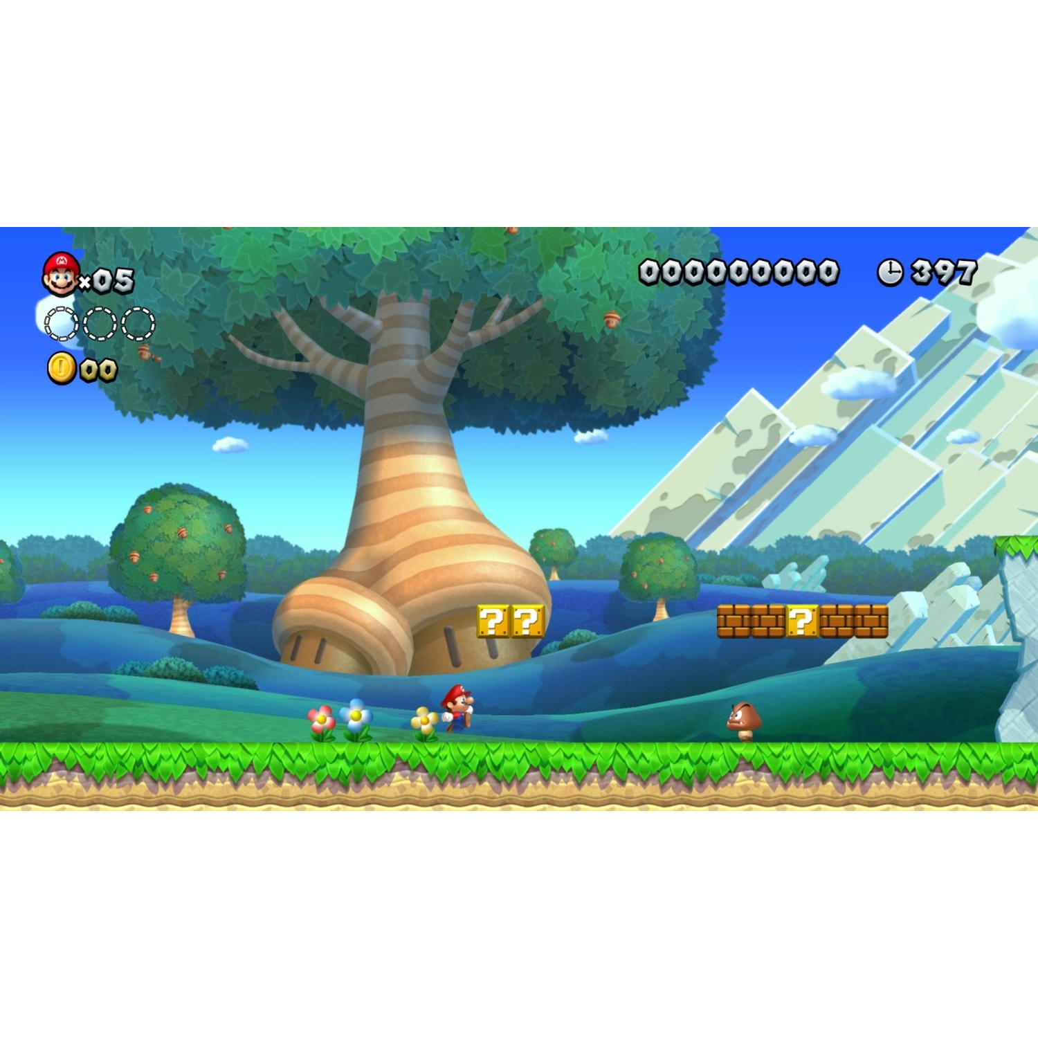 Mario runs on a green meadow with flowers and trees. A large tree is in the background.