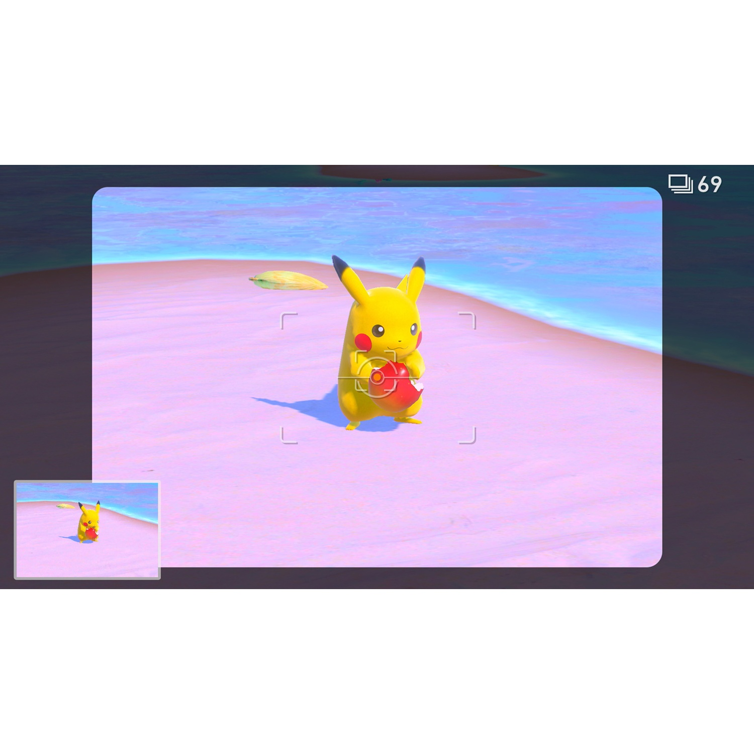 Pikachu holding a red ball on a pink beach with blue water in the background.