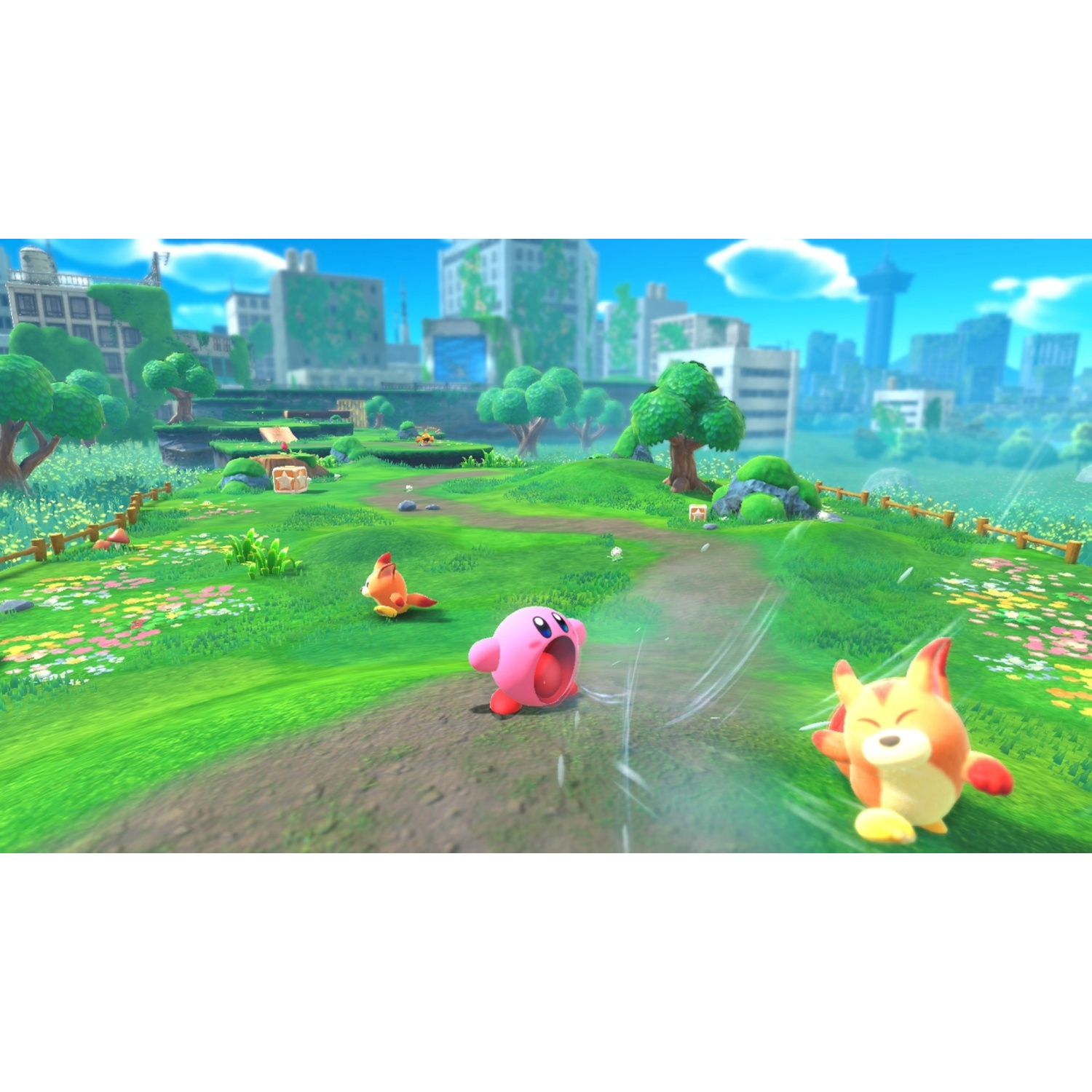 Pink Kirby runs on a path through a green landscape with buildings in the background.