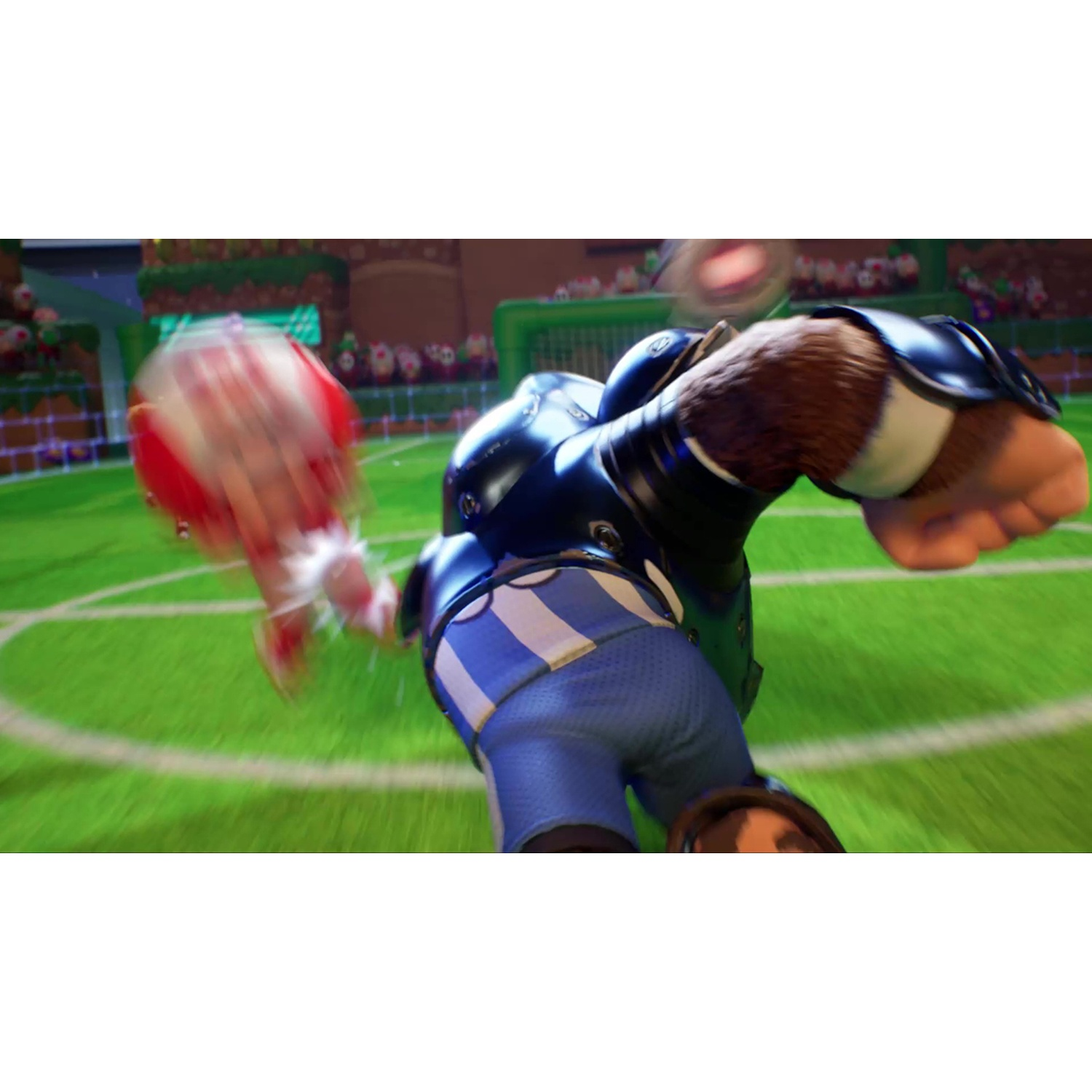 A gorilla in football gear punches a ball on a green field.